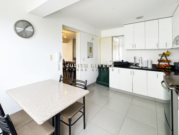 Comedor de diario con mesa de granito claro y cuatro sillas junto a la cocina